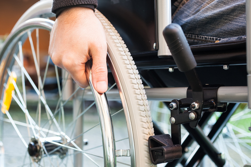 A close-up of a wheelchair wheel used by a client following an amputation claim