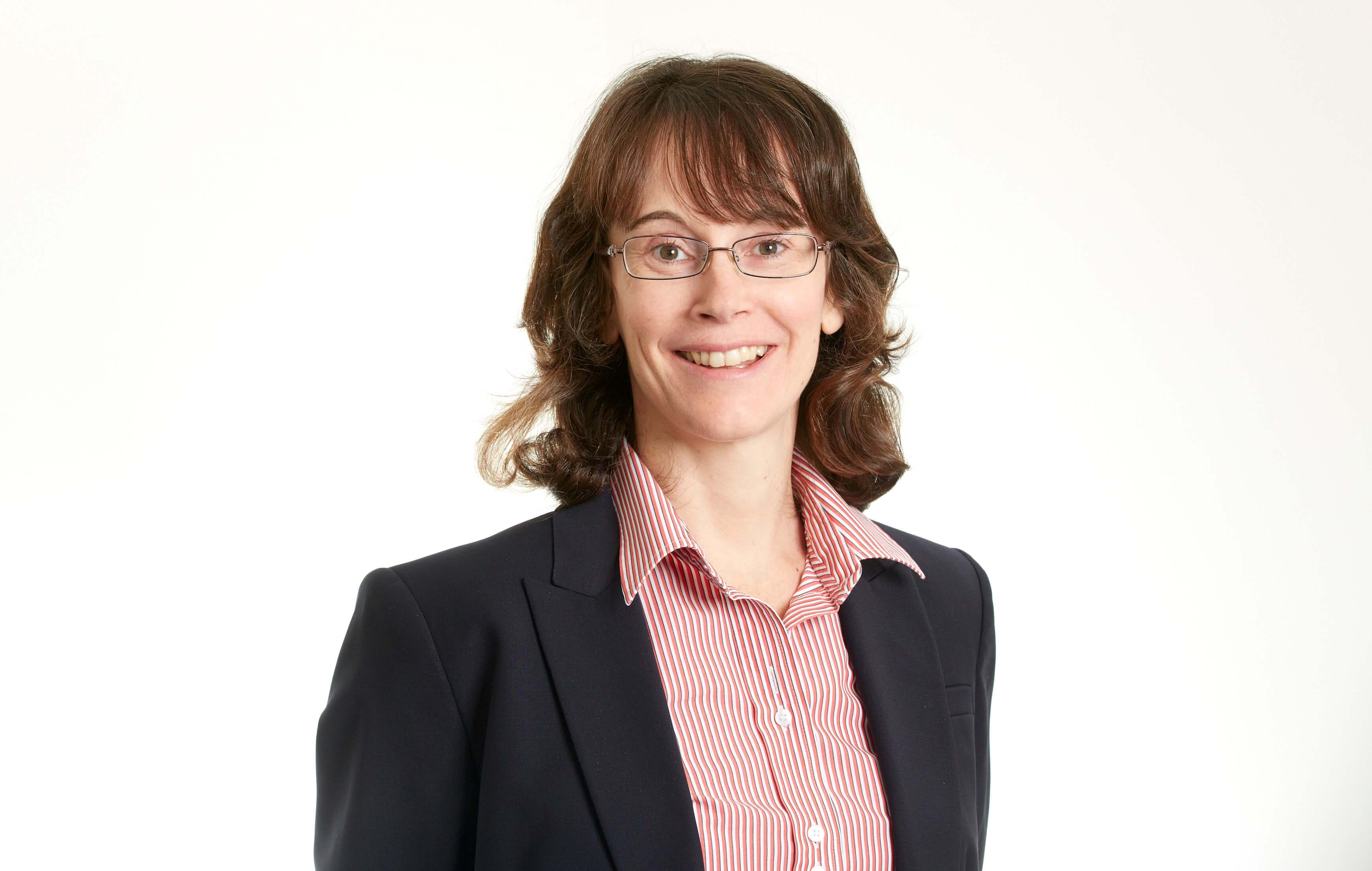 Rachel Halliday, senior case handler at Thompsons Solicitors in Manchester, wearing a suit jacket and red shirt.