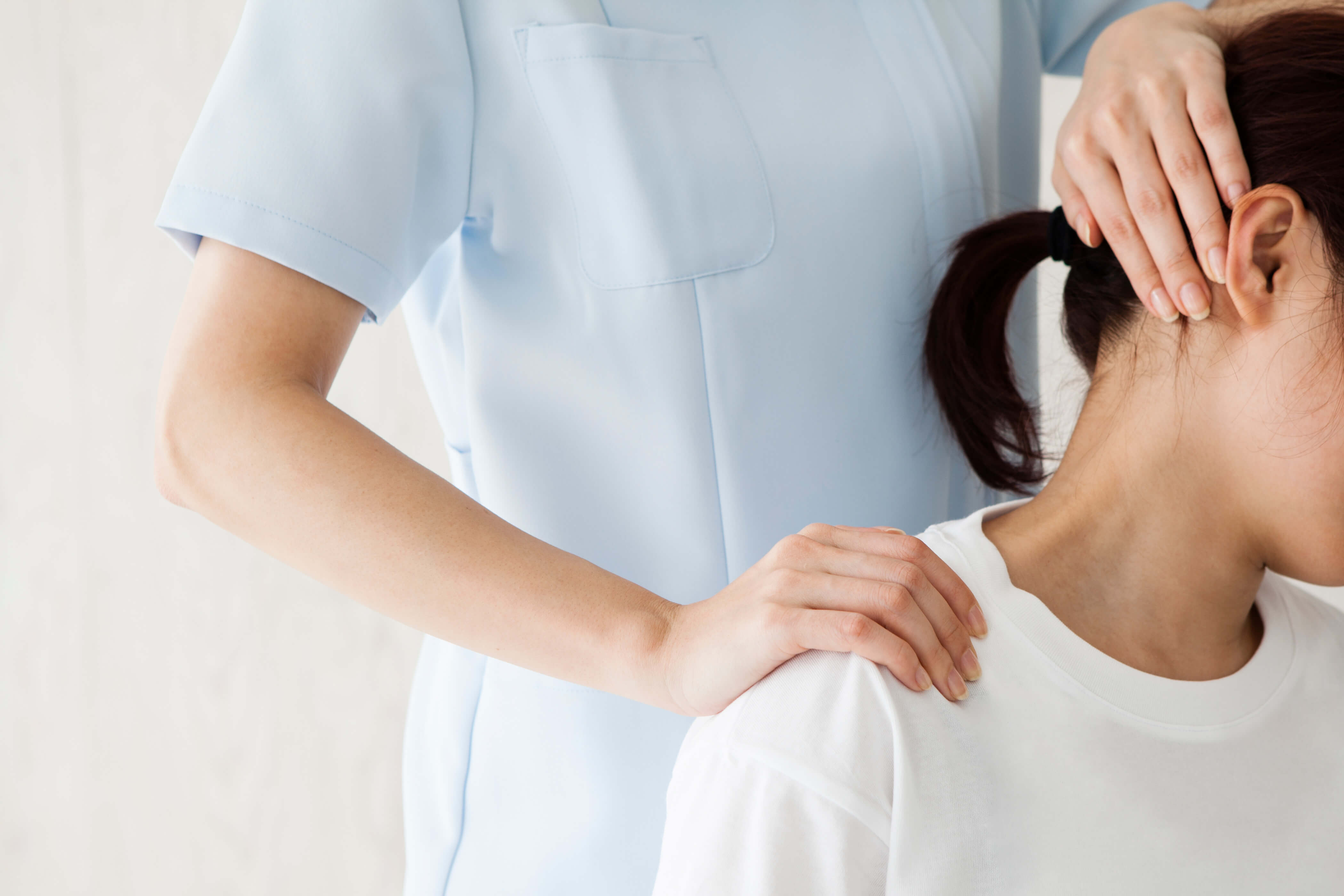 A woman receives treatment from a nurse for a dislocated shoulder after an accident at work.