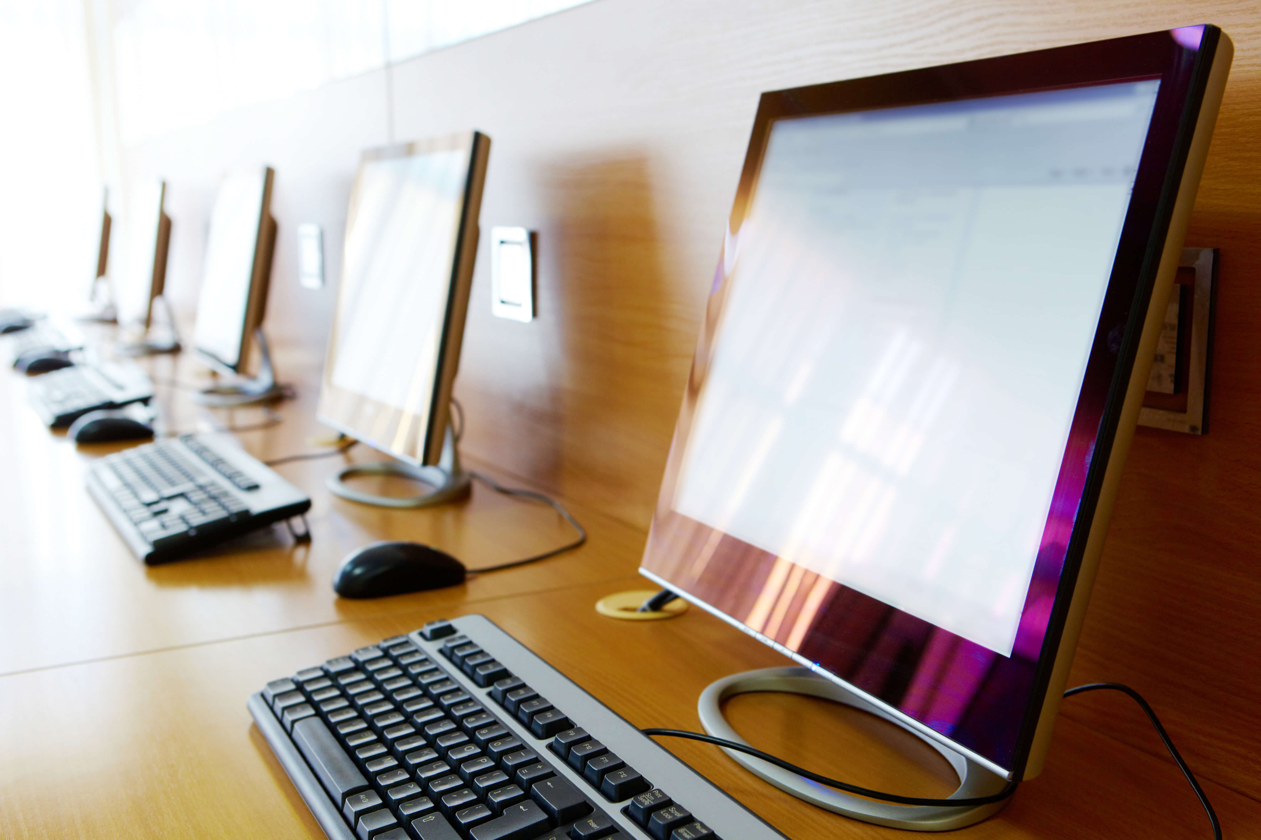 A row of desktop computers used by students