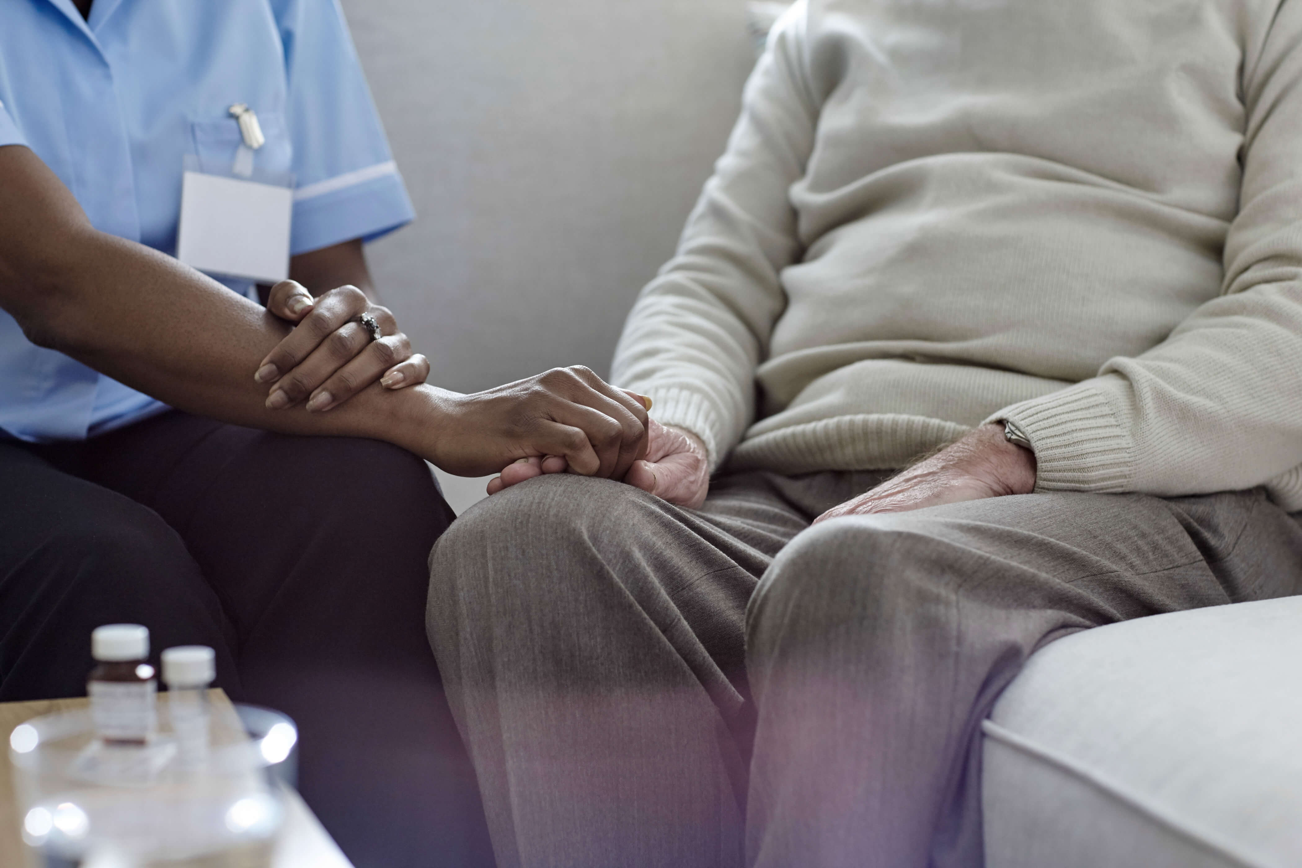 Medical professional holds a patient's hand in the hospital