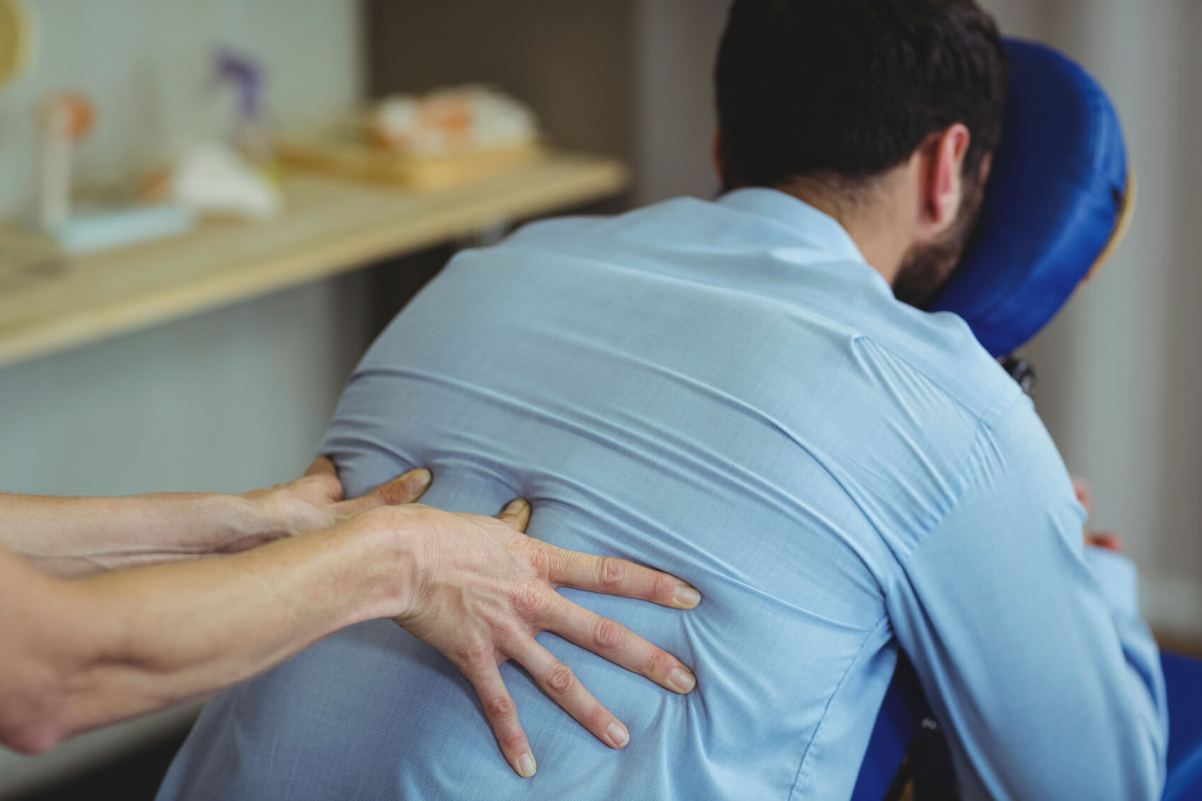 A man receiving back massage treatment following a back injury