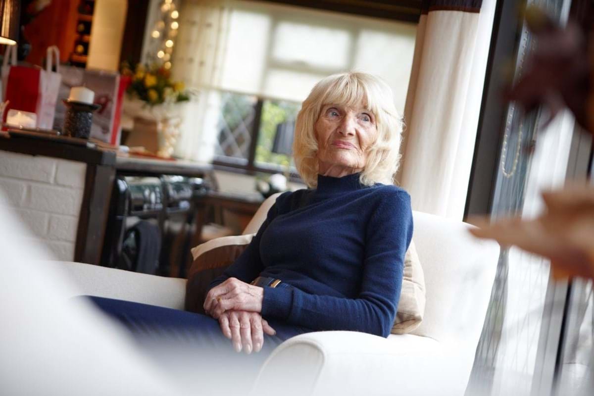 Patricia Jolliffe sitting at home