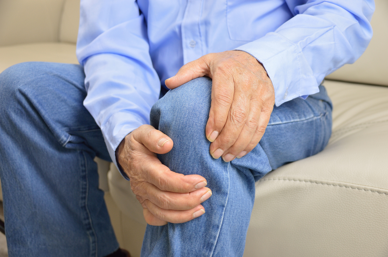 Person holds their injured knee