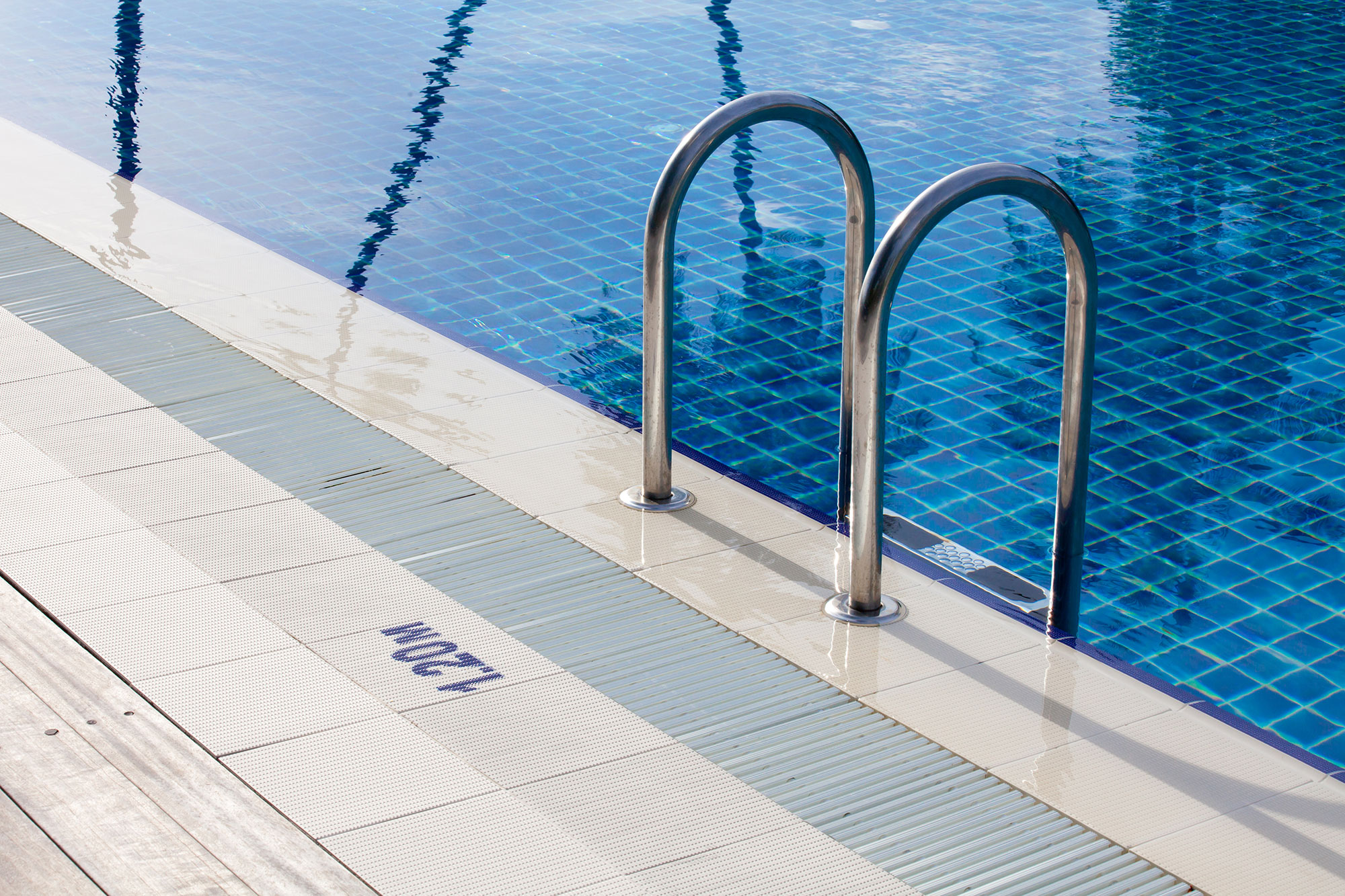 The side of a swimming pool, where our client developed a skin disease after her employer failed to provide her proper equipment.