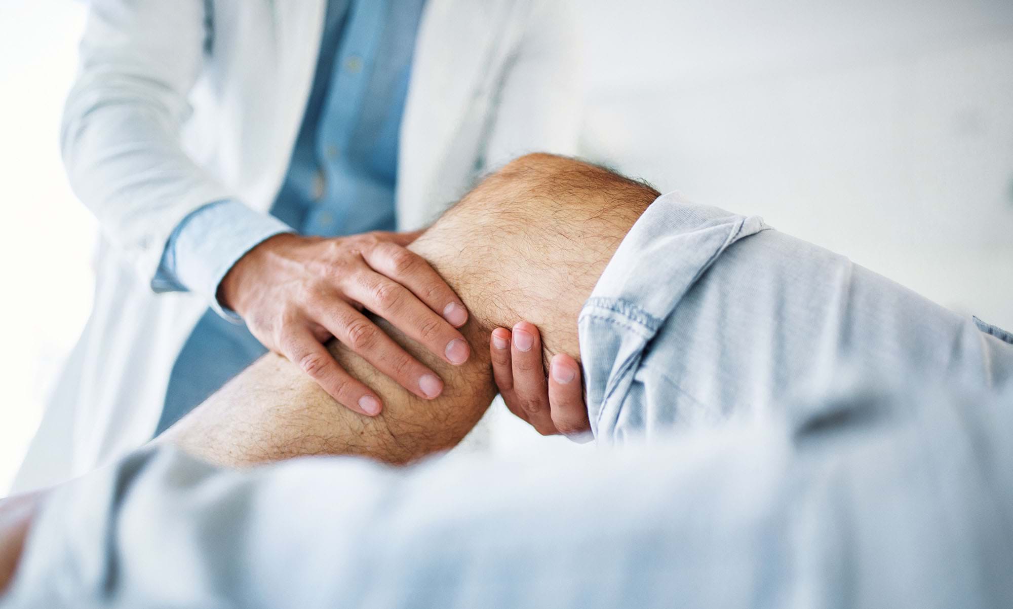 A doctor treats a knee injury.