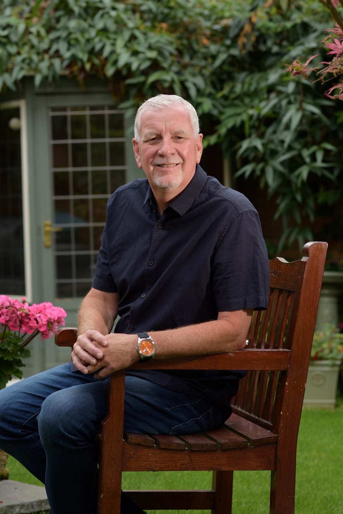 Graham Trayling sat on a garden bench