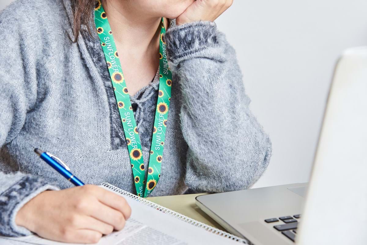 A woman wearing a sunflower lanyard